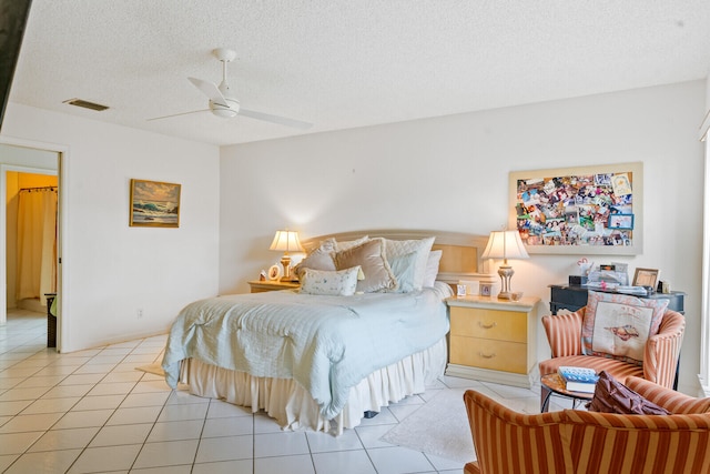 tiled bedroom featuring a textured ceiling and ceiling fan