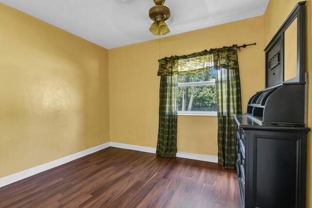 unfurnished bedroom featuring dark wood-type flooring and a closet