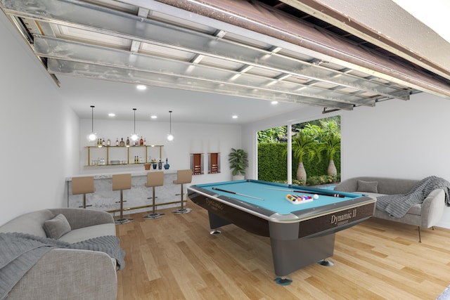 rec room with indoor bar, light hardwood / wood-style floors, and pool table