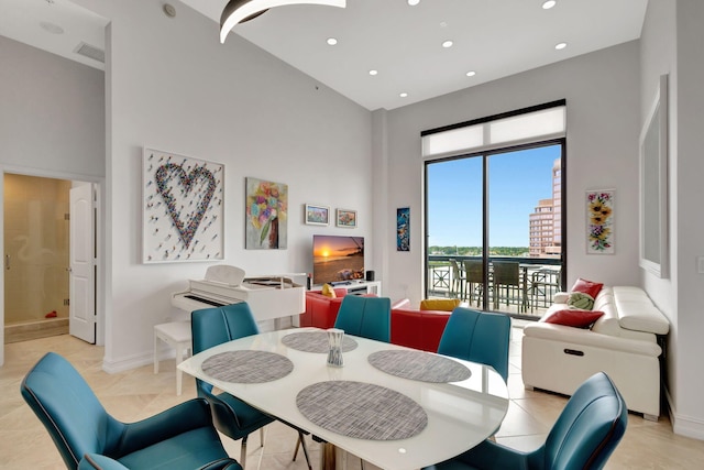 tiled dining room featuring a high ceiling