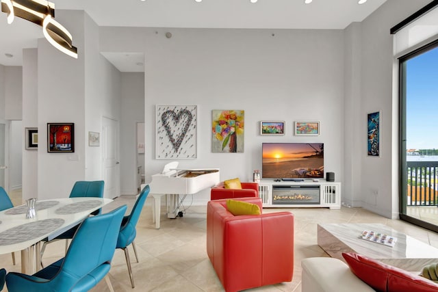 living room with light tile patterned floors and a high ceiling