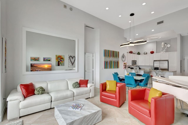 tiled living room featuring a towering ceiling