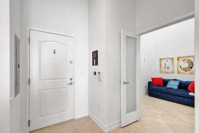 entrance foyer with a towering ceiling and light tile patterned flooring