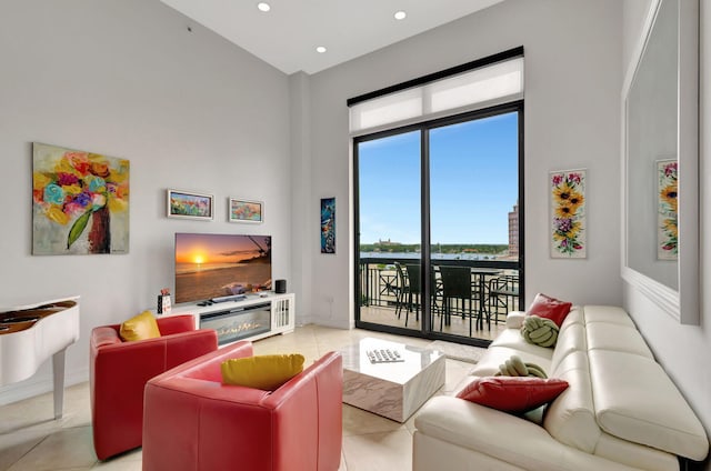 living room featuring light tile patterned floors and a high ceiling