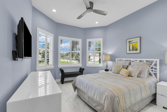 bedroom with a ceiling fan, recessed lighting, marble finish floor, and multiple windows