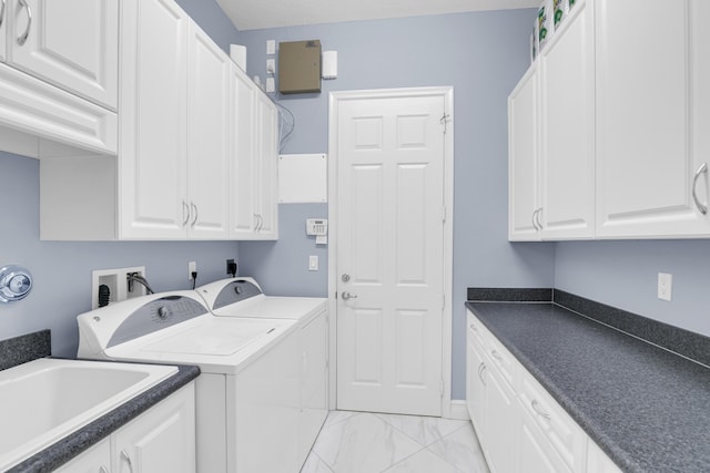 clothes washing area with marble finish floor, cabinet space, a sink, and separate washer and dryer