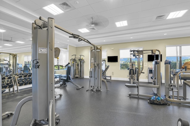 workout area featuring a paneled ceiling, visible vents, and baseboards