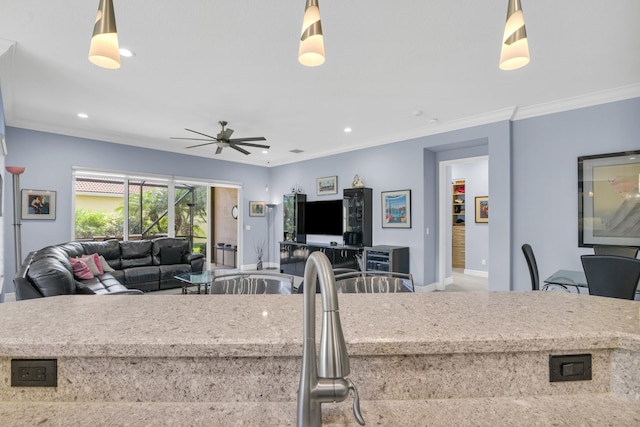 kitchen with a ceiling fan, ornamental molding, open floor plan, pendant lighting, and recessed lighting