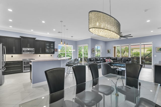 dining space featuring plenty of natural light, ornamental molding, and recessed lighting