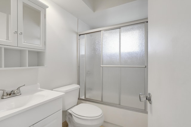 full bathroom with bath / shower combo with glass door, vanity, and toilet