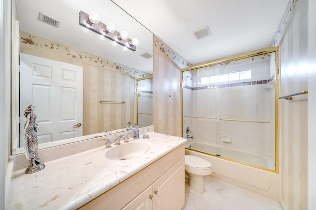 full bathroom with vanity, shower / bath combination with glass door, tile patterned floors, toilet, and a textured ceiling