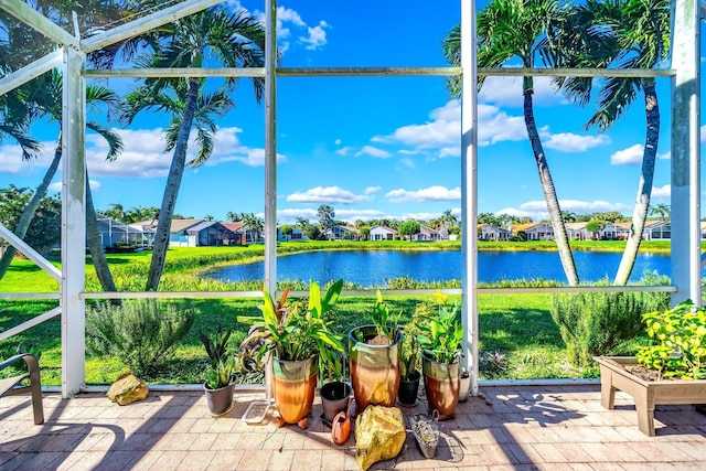 unfurnished sunroom with a water view