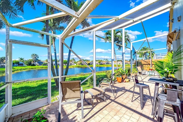 sunroom / solarium featuring a water view