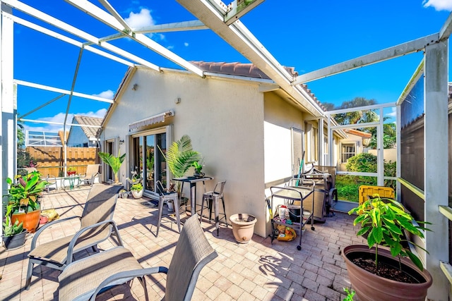 view of patio / terrace featuring glass enclosure