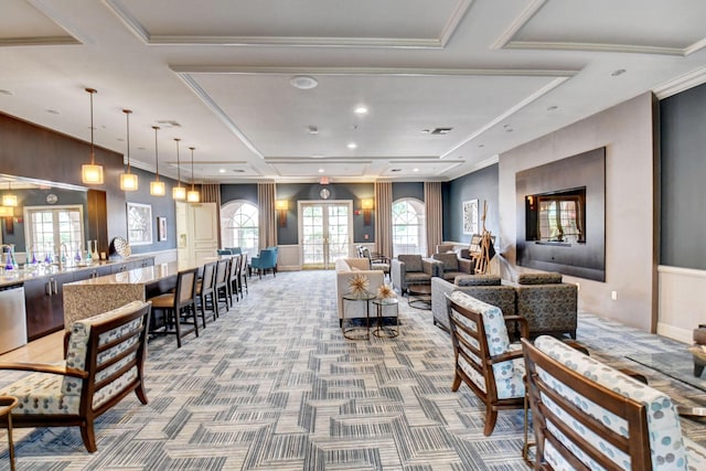 carpeted living room with french doors and ornamental molding