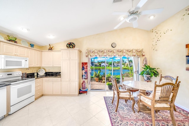 kitchen featuring ceiling fan, cream cabinets, vaulted ceiling, white appliances, and light tile patterned floors