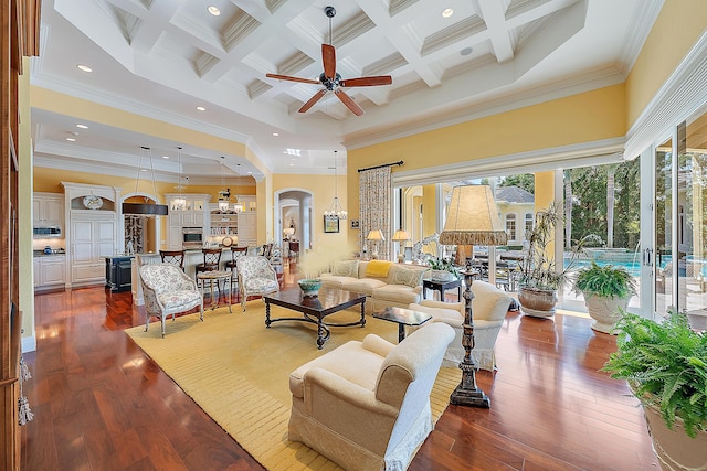 living room featuring coffered ceiling, ceiling fan with notable chandelier, crown molding, beamed ceiling, and a high ceiling