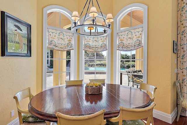 dining space featuring hardwood / wood-style floors and a notable chandelier