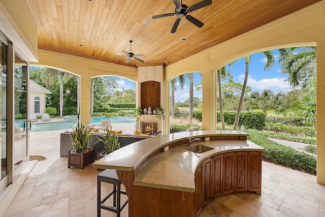 view of patio / terrace featuring ceiling fan and a wet bar