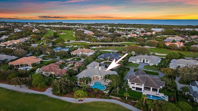 aerial view at dusk with a water view