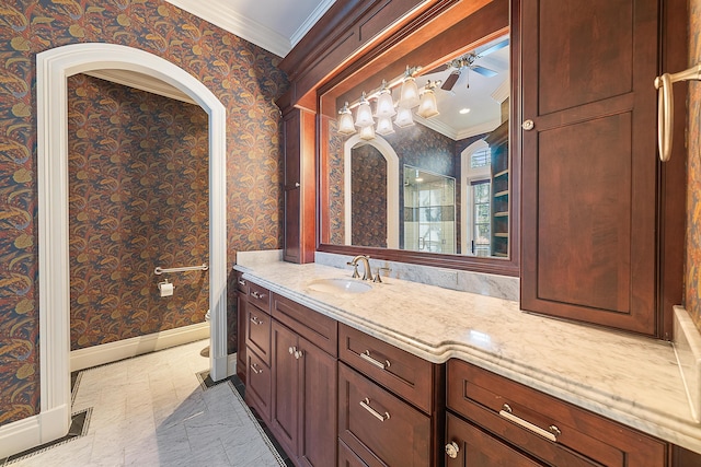 bathroom with crown molding, vanity, and toilet