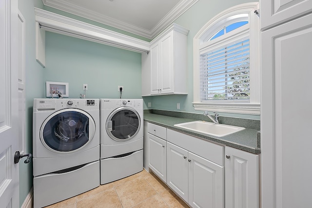 laundry area with cabinets, crown molding, sink, light tile patterned floors, and washing machine and dryer