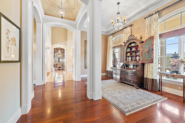 interior space with a healthy amount of sunlight, crown molding, and hardwood / wood-style floors