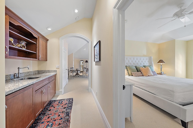 interior space with light colored carpet, lofted ceiling, and sink