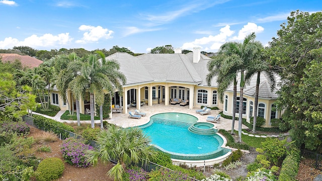 view of pool with an in ground hot tub, a patio, and an outdoor living space