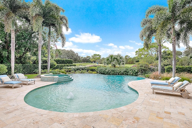 view of swimming pool with an in ground hot tub and a patio area