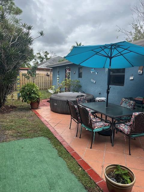 view of patio / terrace with a hot tub