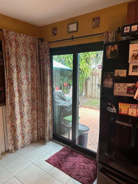 doorway with light tile patterned floors