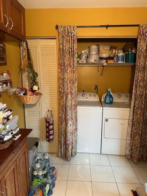 laundry room with light tile patterned floors and independent washer and dryer