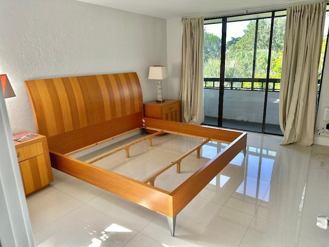 tiled bedroom with access to outside and expansive windows