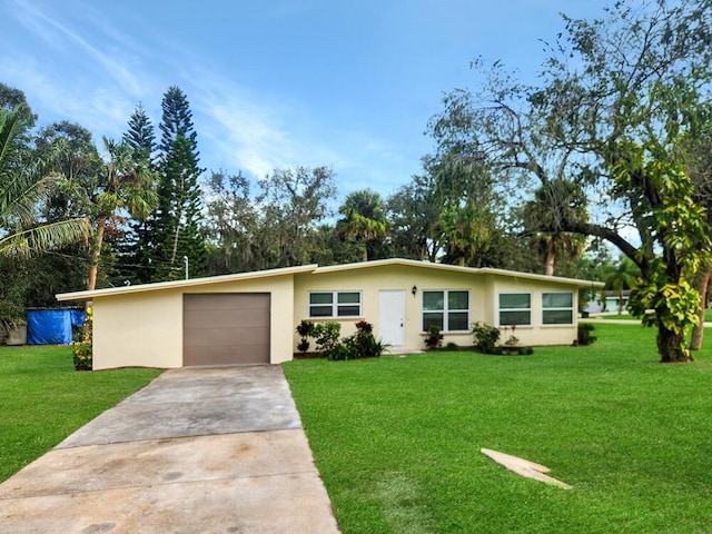 ranch-style house featuring a front lawn and a garage