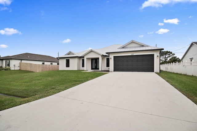 view of front of home featuring a garage and a front lawn