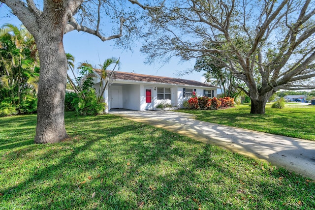 ranch-style home with stucco siding, concrete driveway, and a front yard