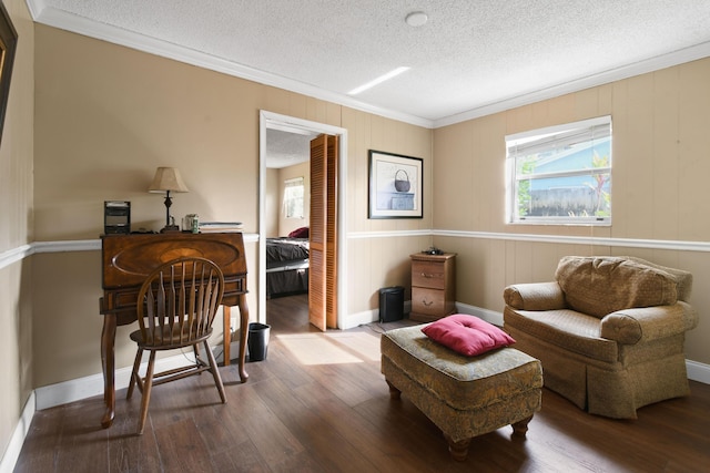 sitting room with crown molding, a textured ceiling, and wood finished floors