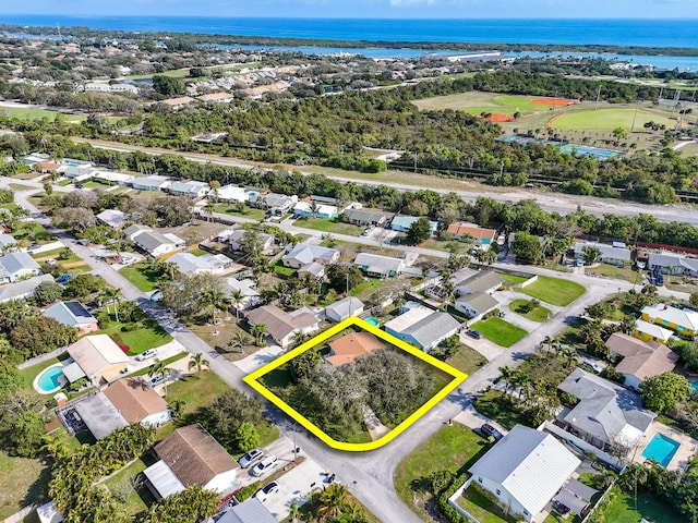 drone / aerial view with a water view and a residential view