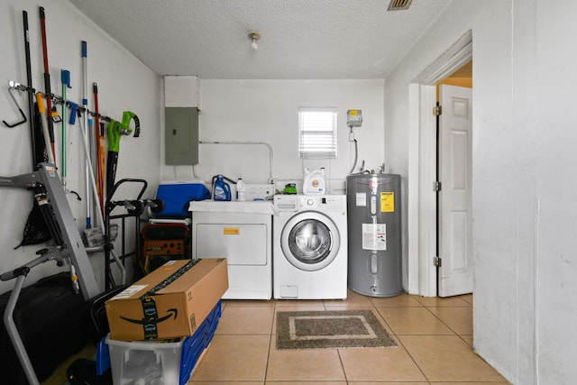 clothes washing area with laundry area, electric panel, washing machine and dryer, water heater, and light tile patterned flooring