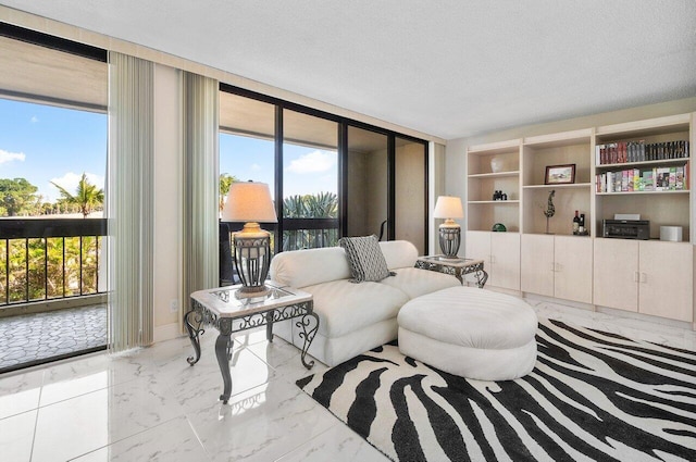 living room featuring a wall of windows, a textured ceiling, and a wealth of natural light