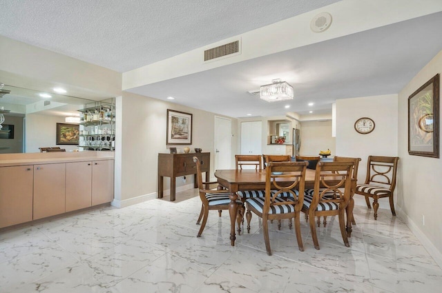 dining space featuring a textured ceiling