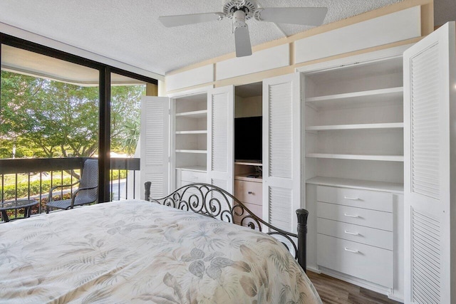 bedroom featuring floor to ceiling windows, ceiling fan, a textured ceiling, and hardwood / wood-style flooring