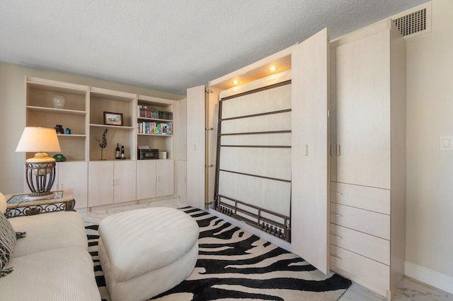 sitting room with a textured ceiling