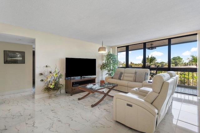 living room featuring expansive windows and a textured ceiling