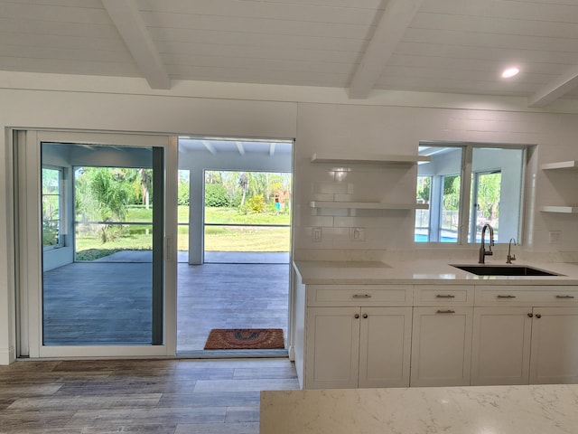 kitchen with white cabinetry, plenty of natural light, and light wood-type flooring