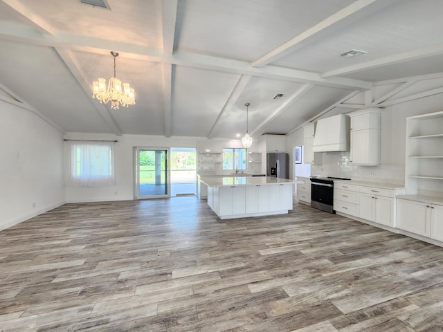 kitchen featuring custom range hood, stainless steel appliances, decorative light fixtures, vaulted ceiling with beams, and white cabinetry