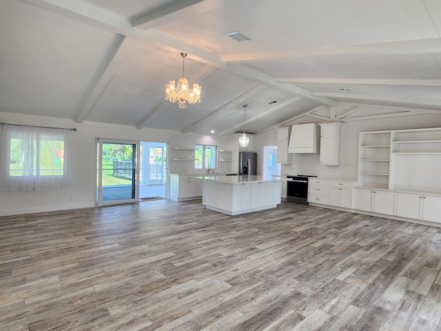 kitchen featuring light wood-type flooring, pendant lighting, white cabinets, stainless steel fridge with ice dispenser, and a center island