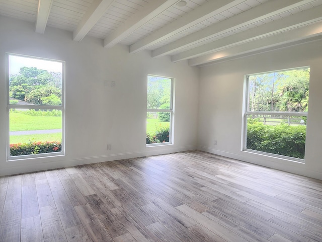 spare room with beamed ceiling, wood ceiling, and light wood-type flooring