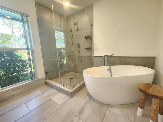 bathroom featuring tile patterned flooring and independent shower and bath